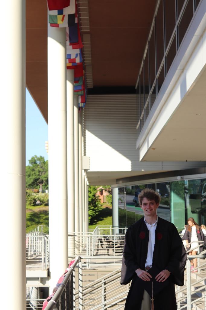 Ben Sachwitz at Darla Moore graduation balcony with international flags